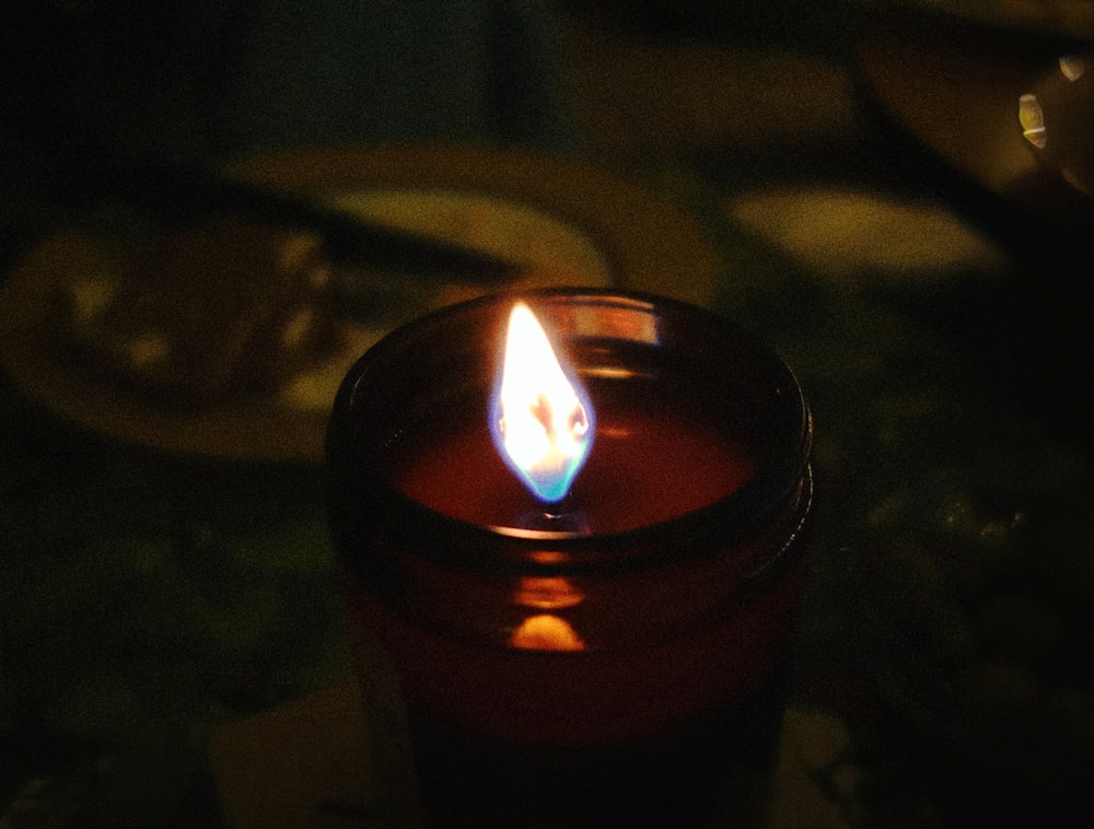 a lit candle sitting on top of a table