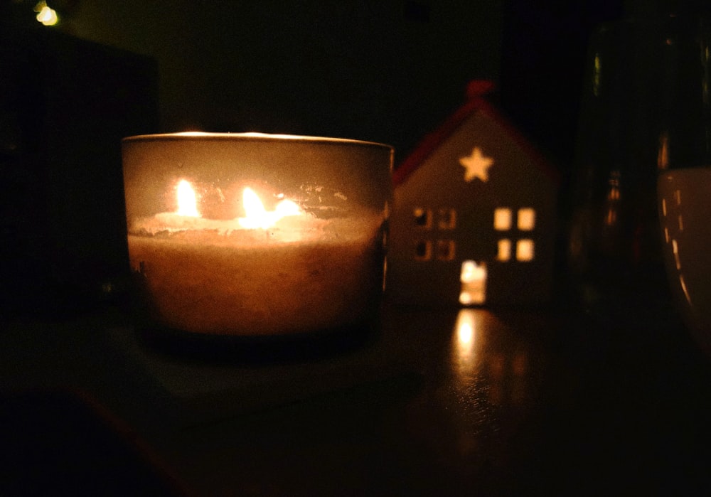 a lit candle sitting on top of a table