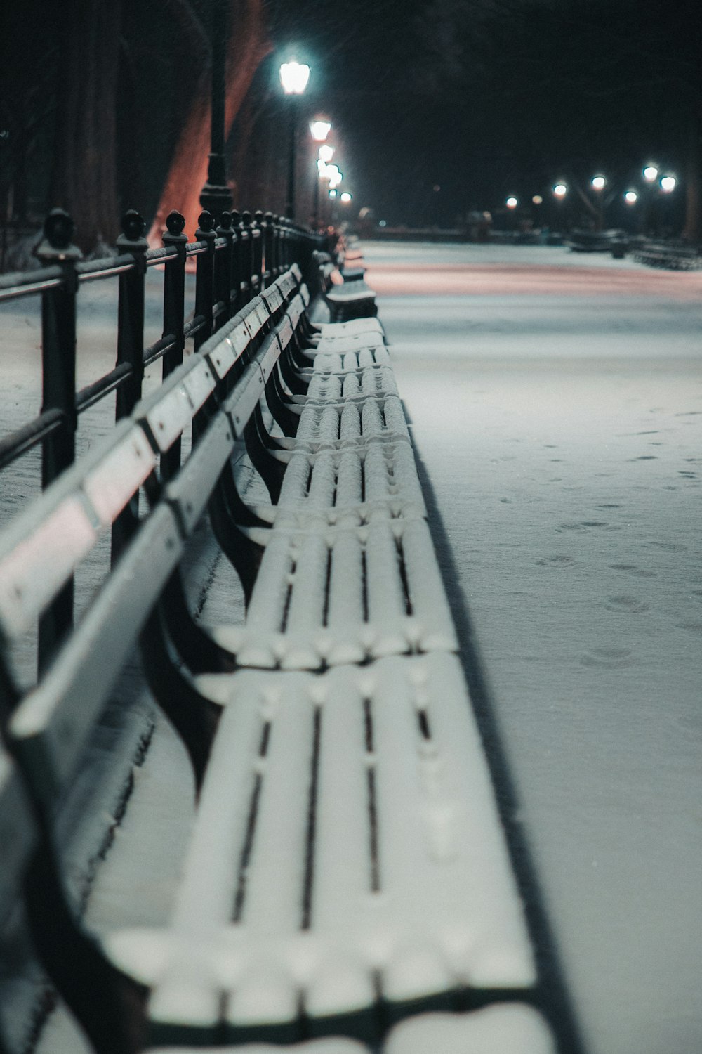 a row of benches sitting next to a street light