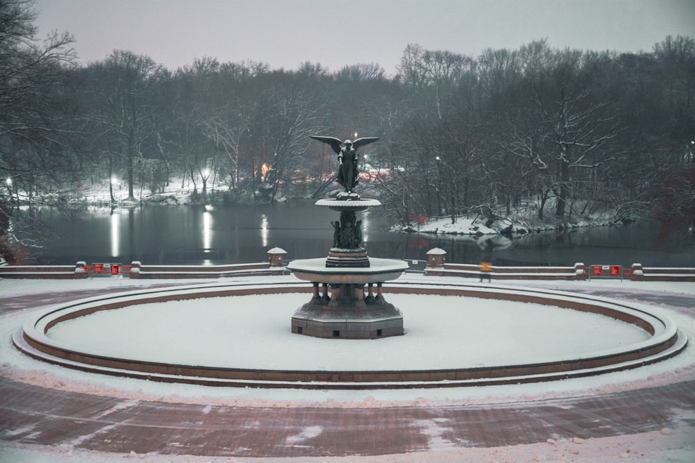 a fountain with a statue in the middle of it