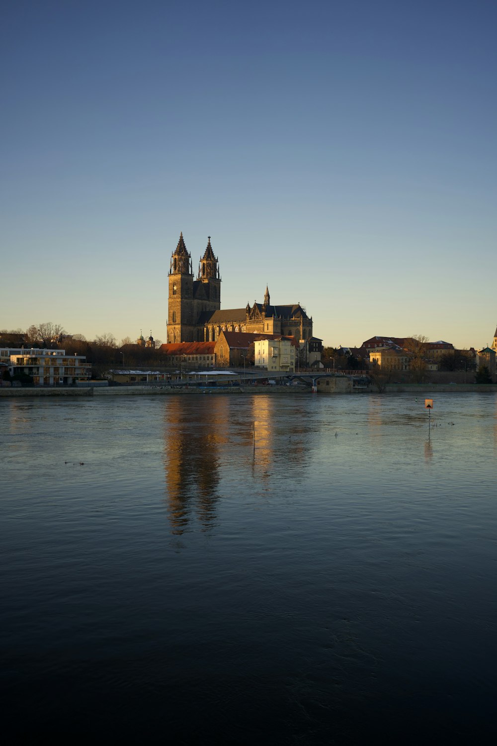 a body of water with a large building in the background