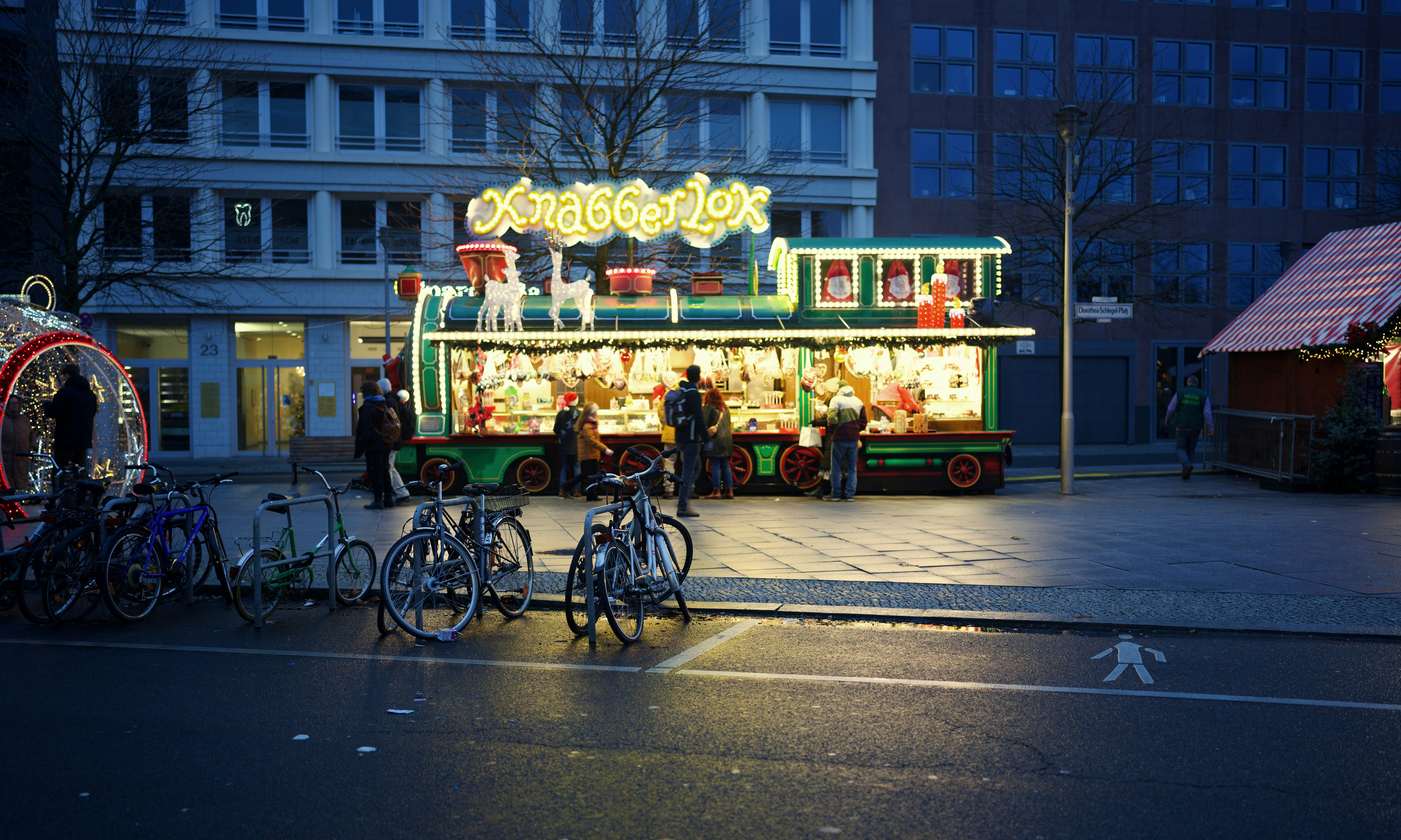 a food truck with people standing outside at night, 