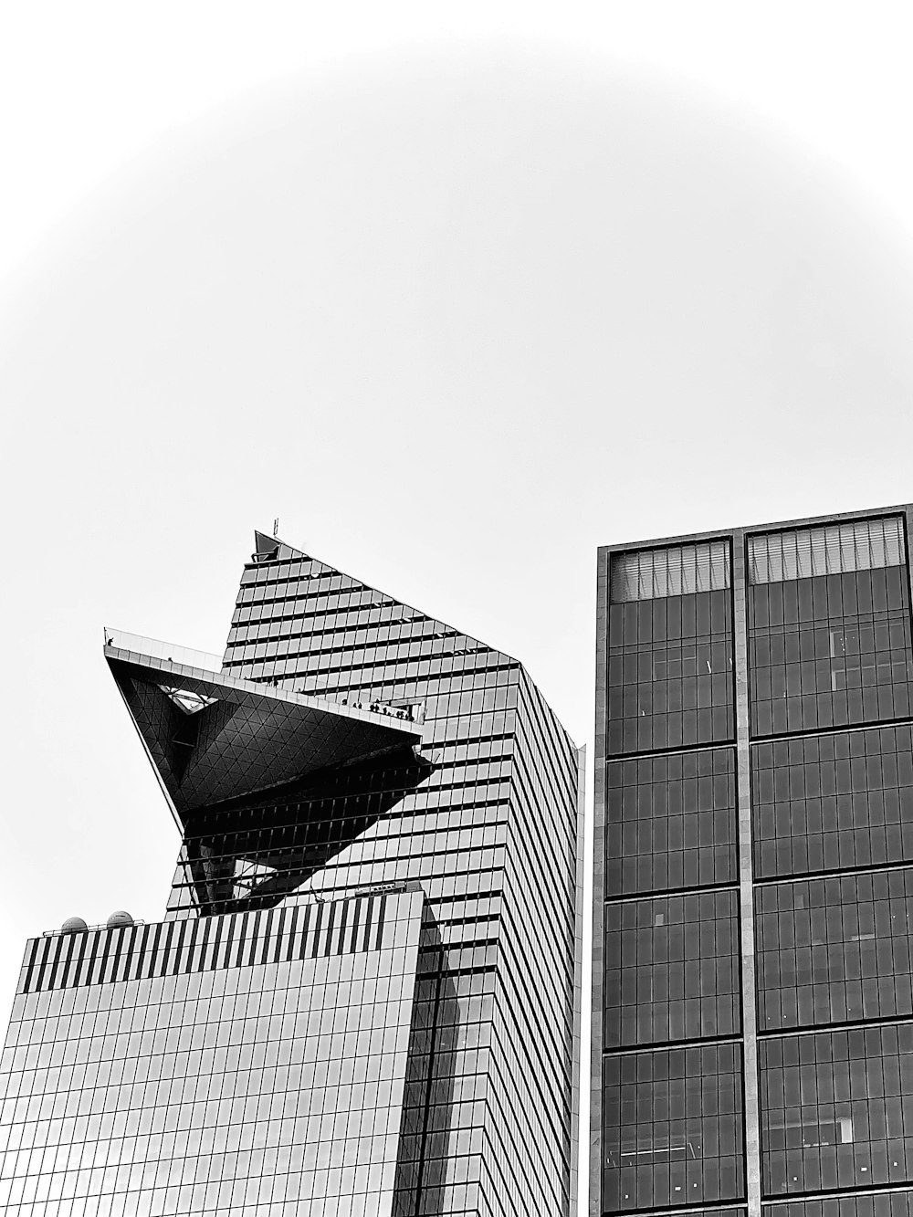 a black and white photo of a building and a clock