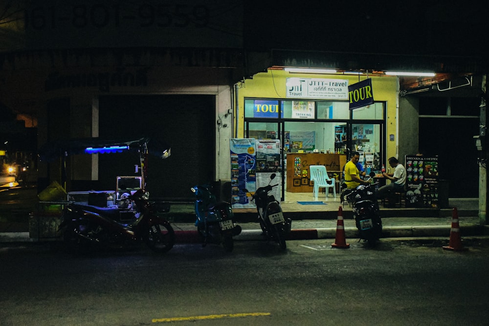 a couple of motorcycles parked in front of a store