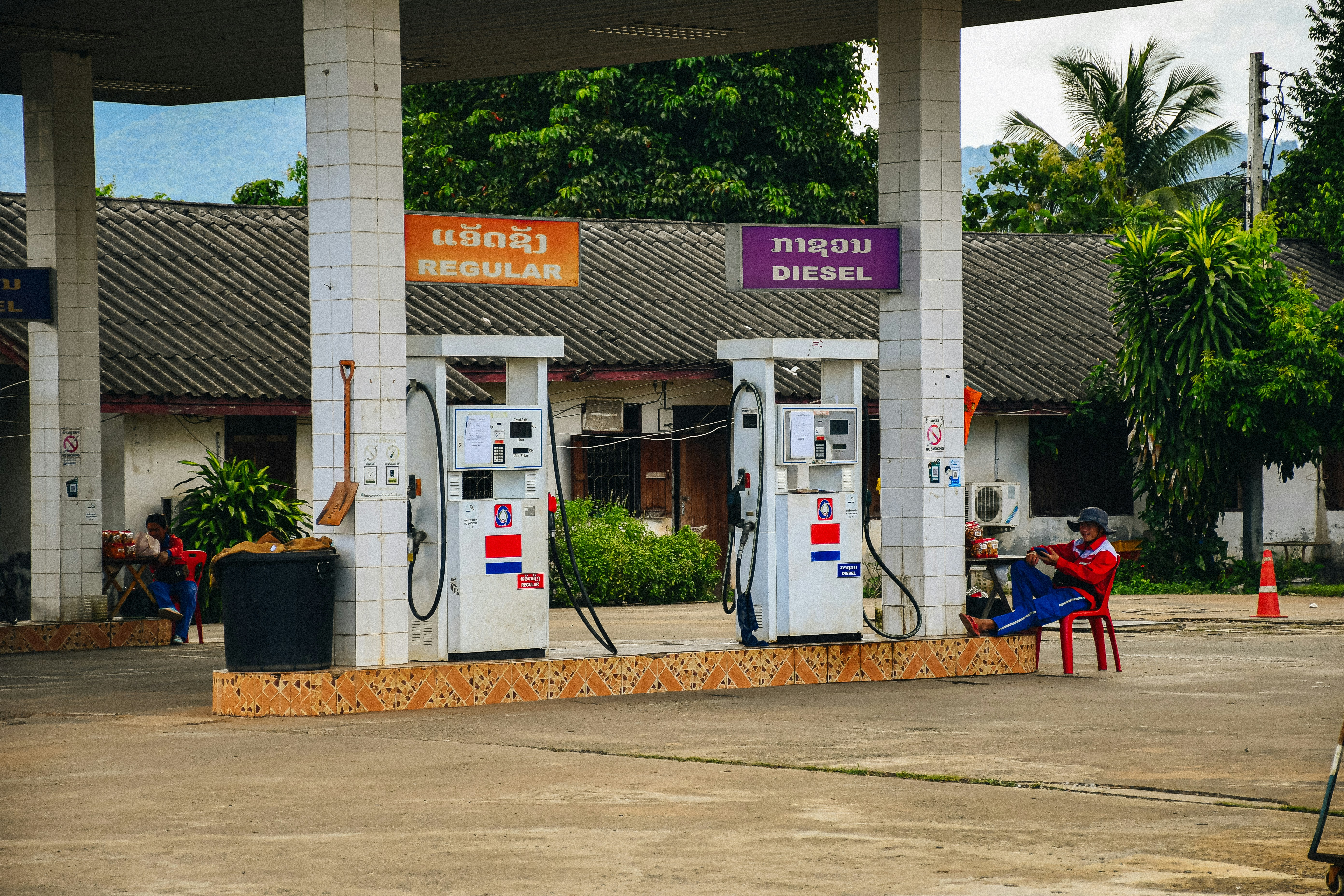 Family loading an electric SUV while it charges at a highway station