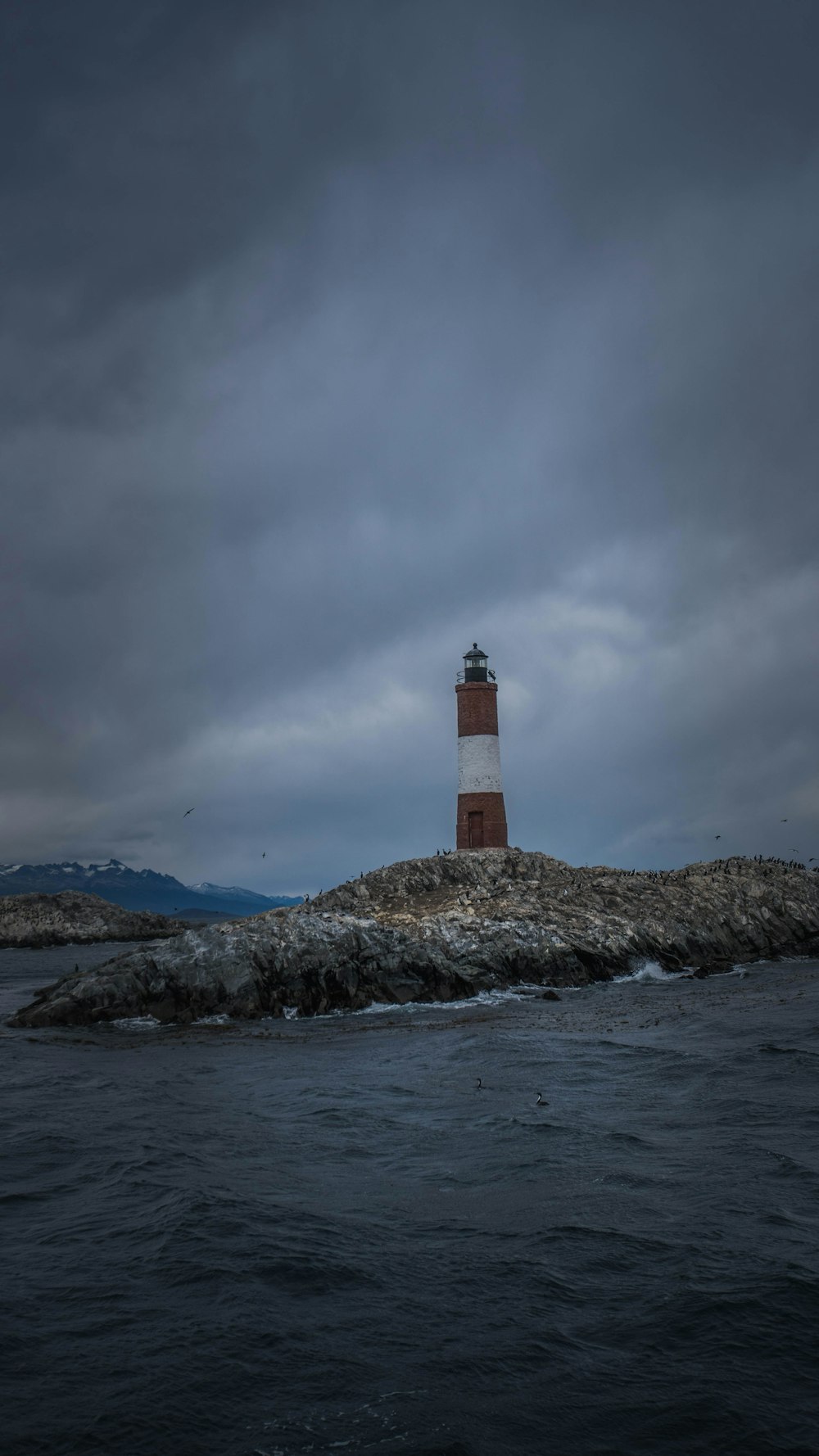 a light house sitting on top of a small island