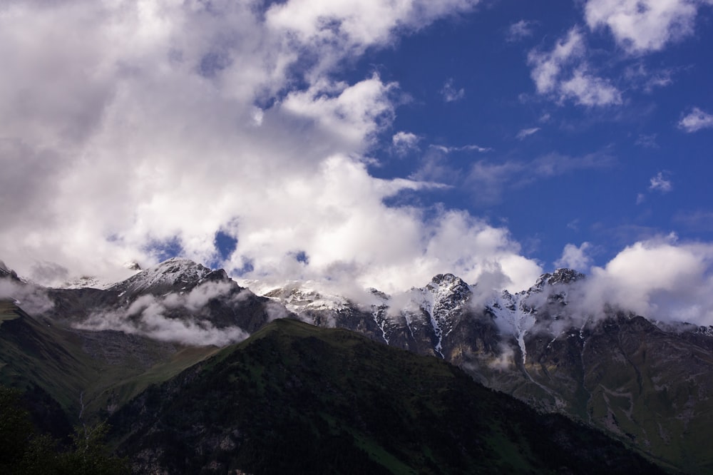 a view of a mountain range with clouds in the sky