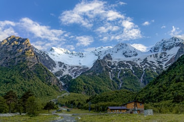 a mountain range with a house in the foreground