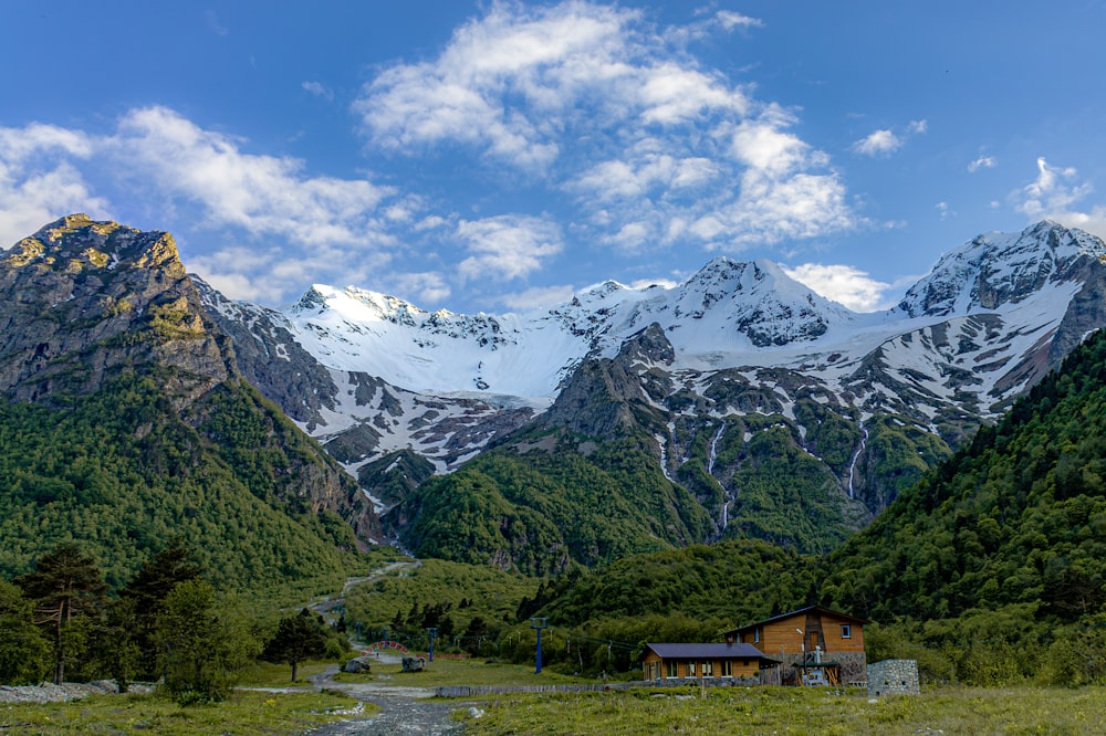 a mountain range with a house in the foreground