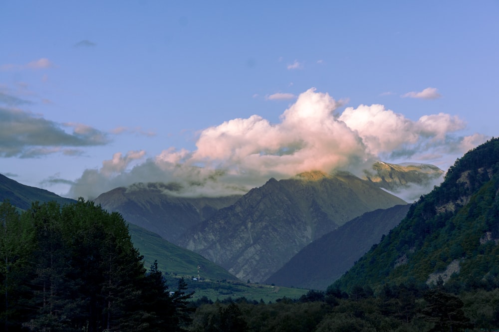 a view of a mountain range with clouds in the sky