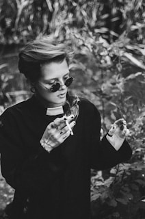 a woman holding a cigarette in her hands