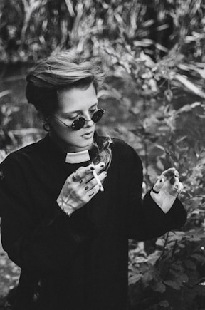 a woman holding a cigarette in her hands