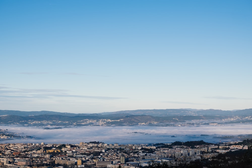 a view of a city in the middle of a foggy day