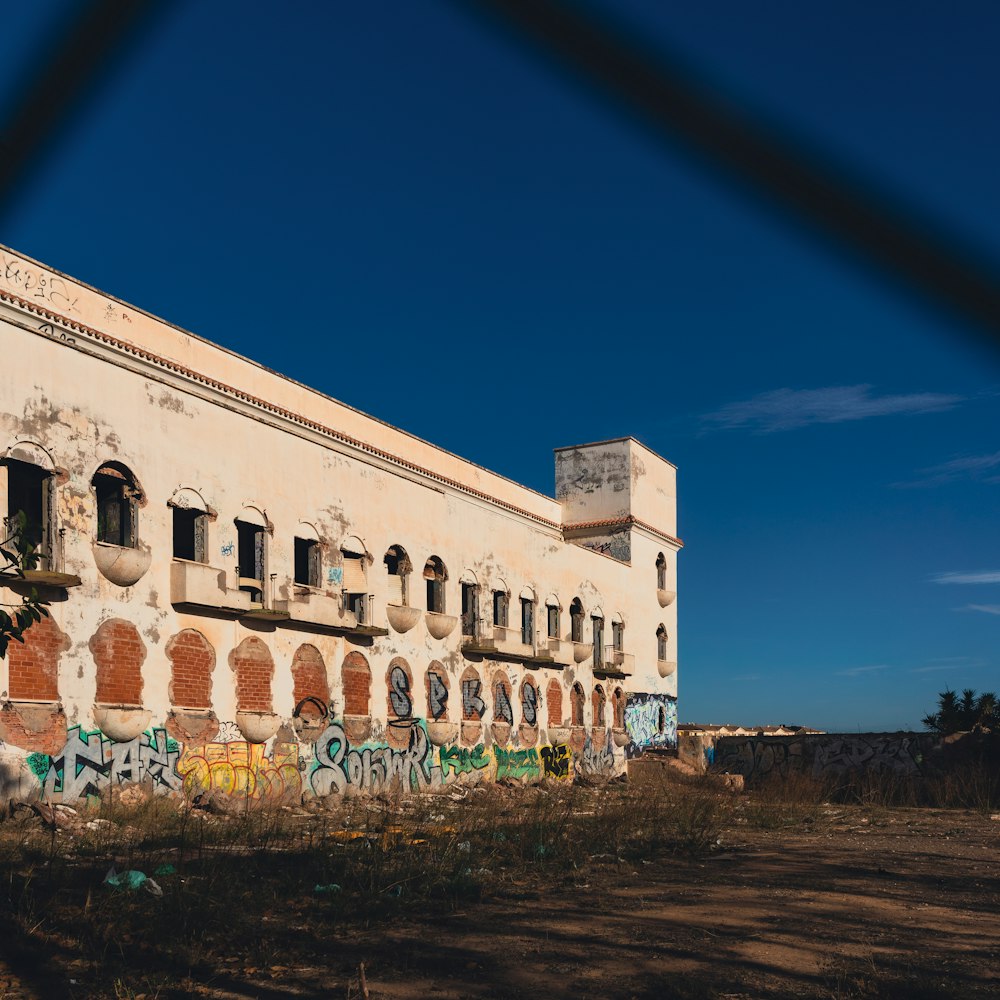 an old building with graffiti on the side of it