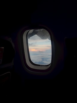 an airplane window with a view of the clouds