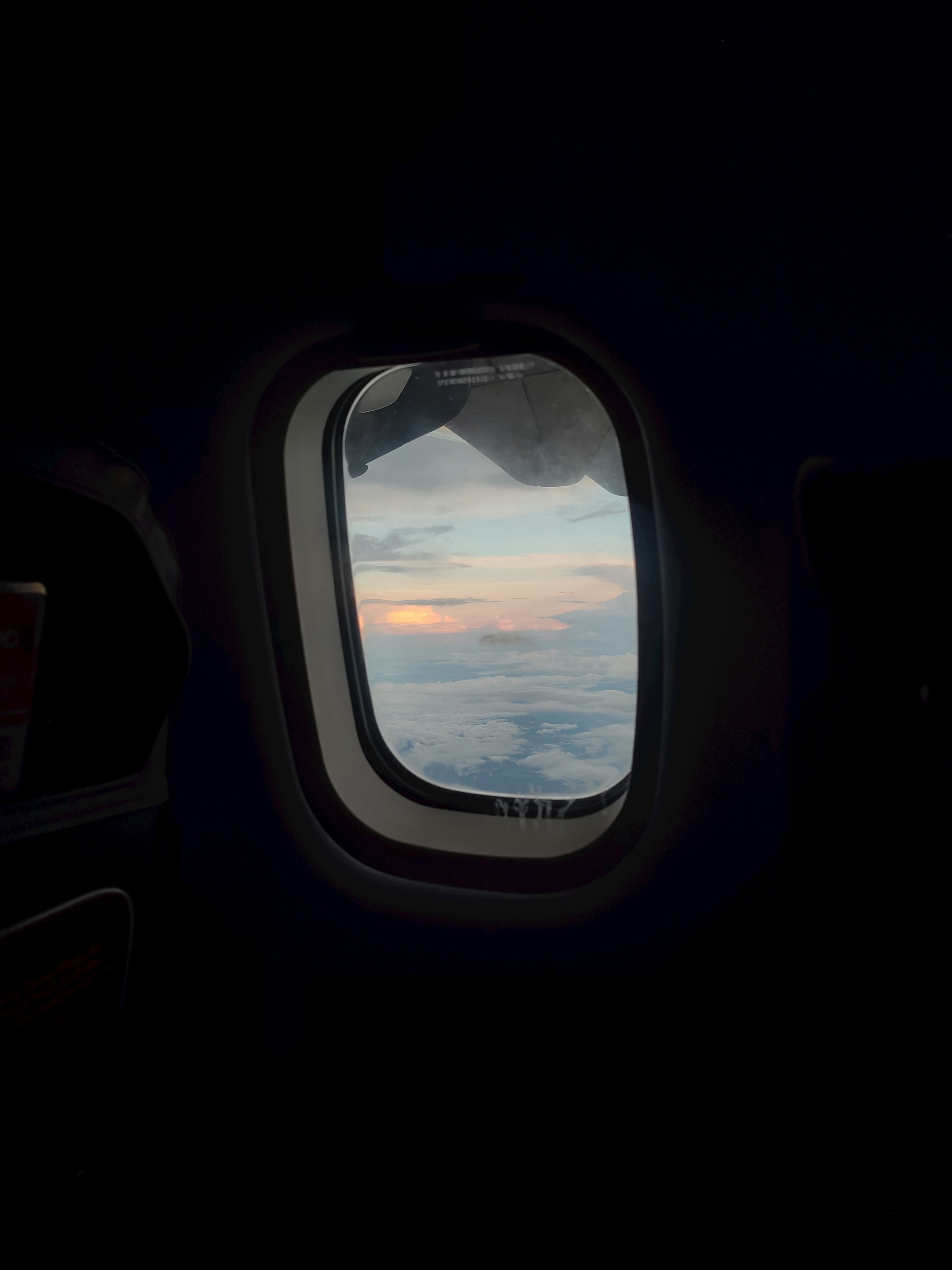 an airplane window with a view of the clouds