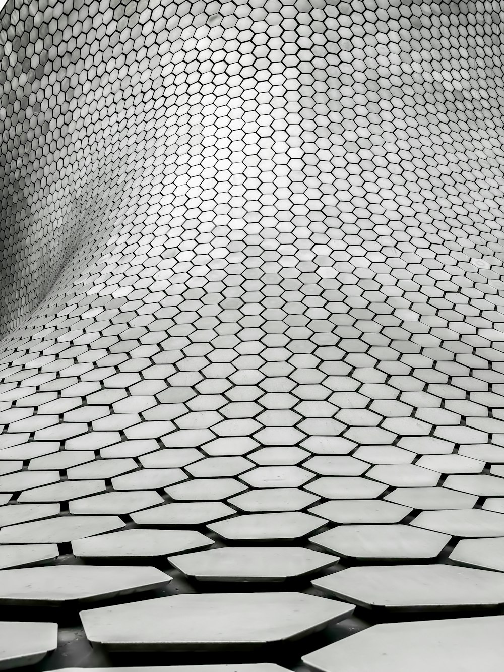 a black and white photo of hexagonal tiles
