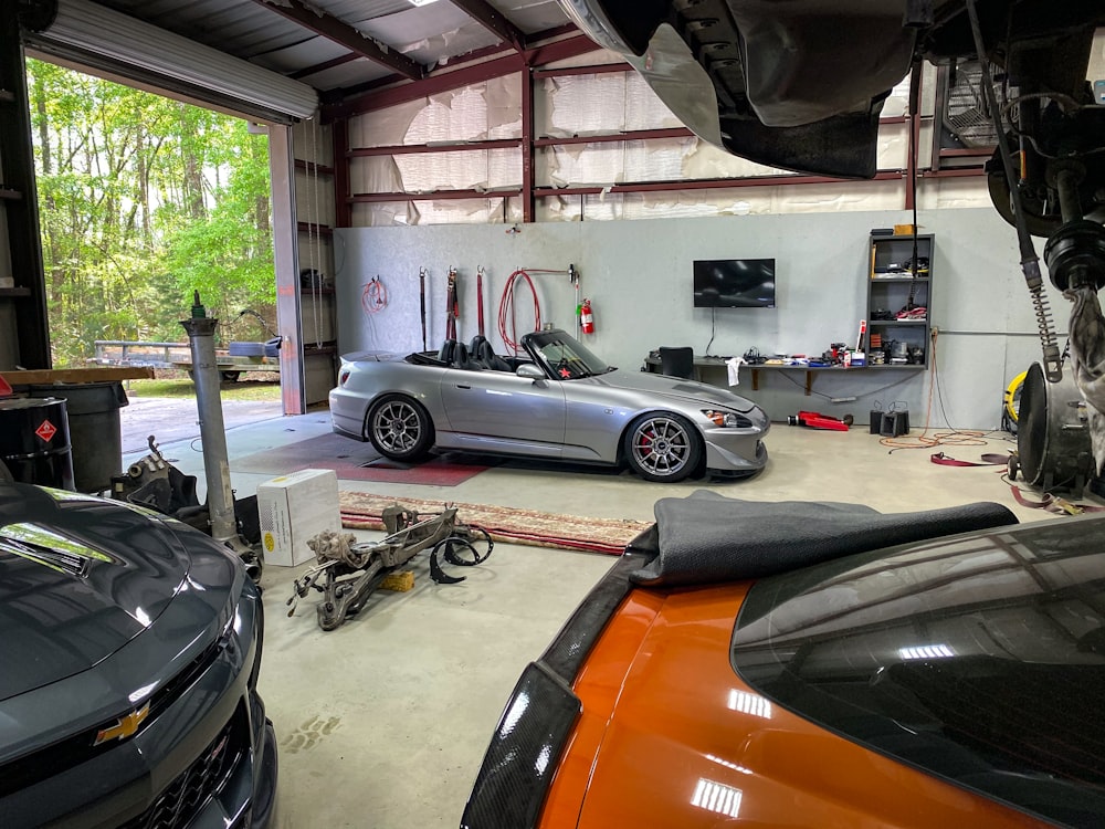a car is parked in a garage with other cars