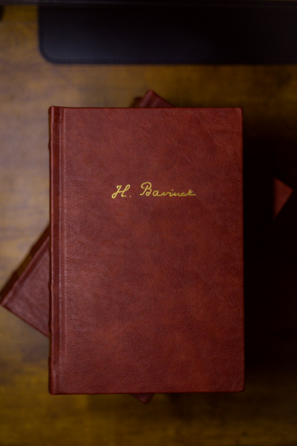 a red book sitting on top of a wooden table