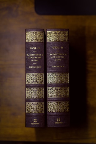 two books sitting on top of a wooden table