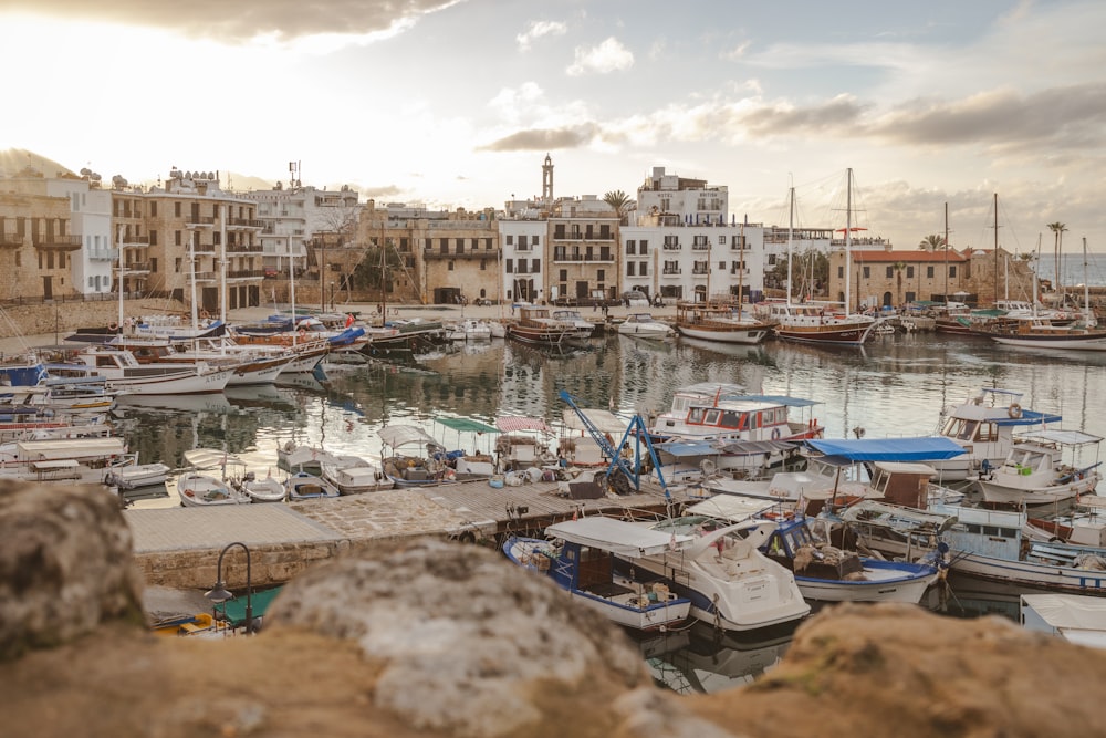 a harbor filled with lots of boats next to tall buildings