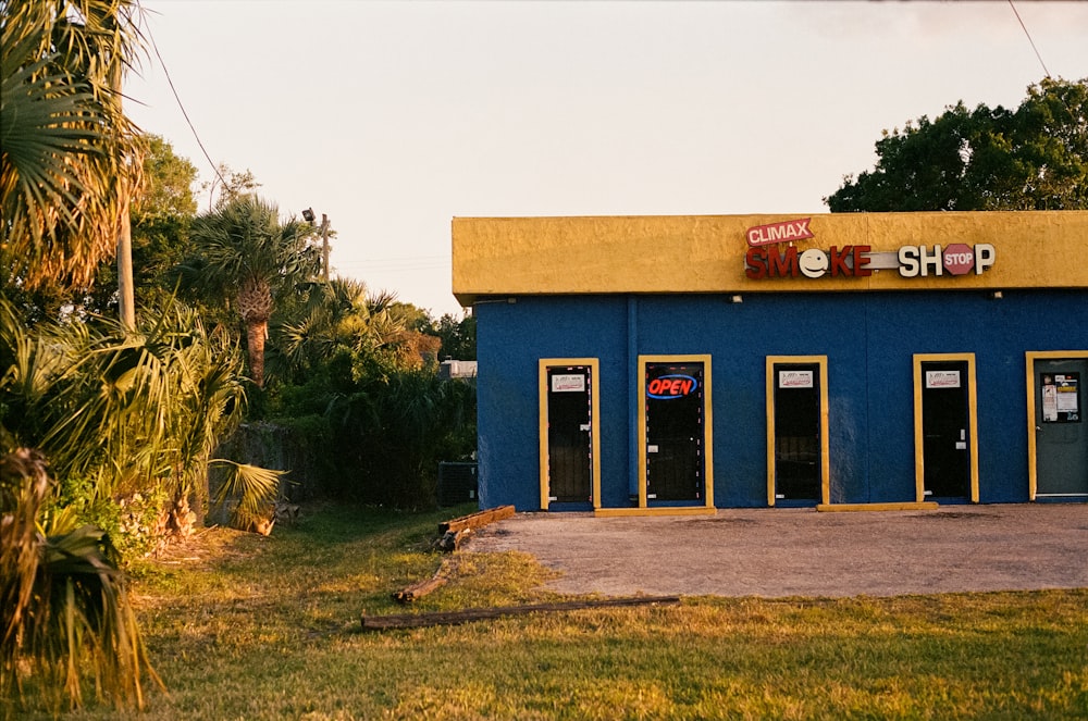 a blue building with yellow trim and doors