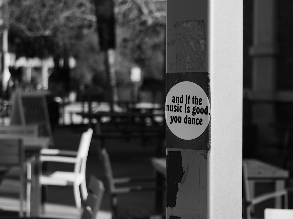 a black and white photo of a sign on a pole