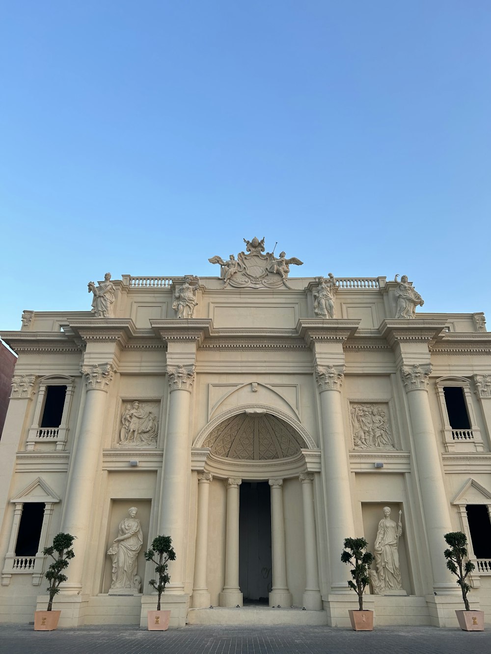 a large white building with statues on the front of it