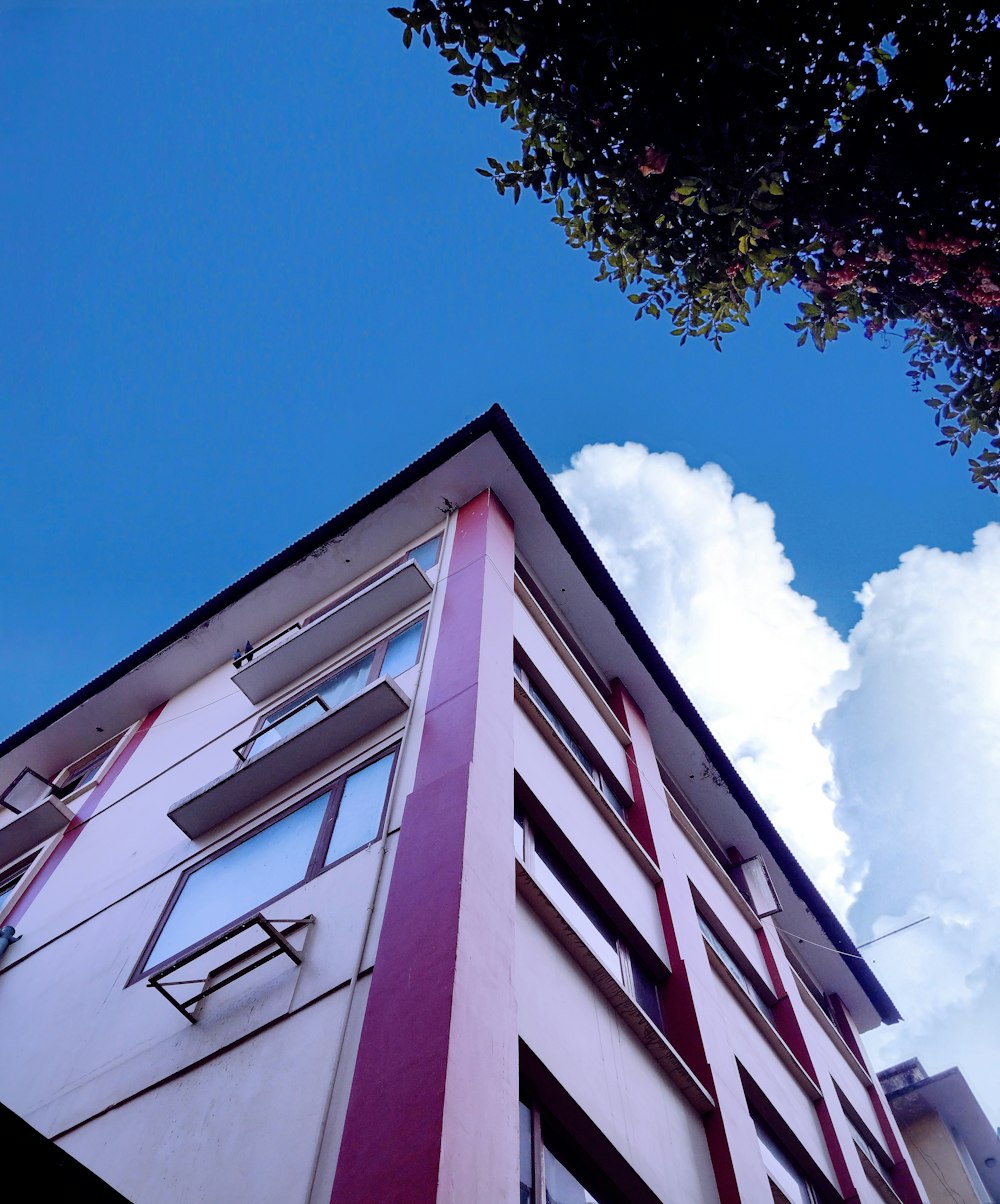 a red and white building with a blue sky in the background