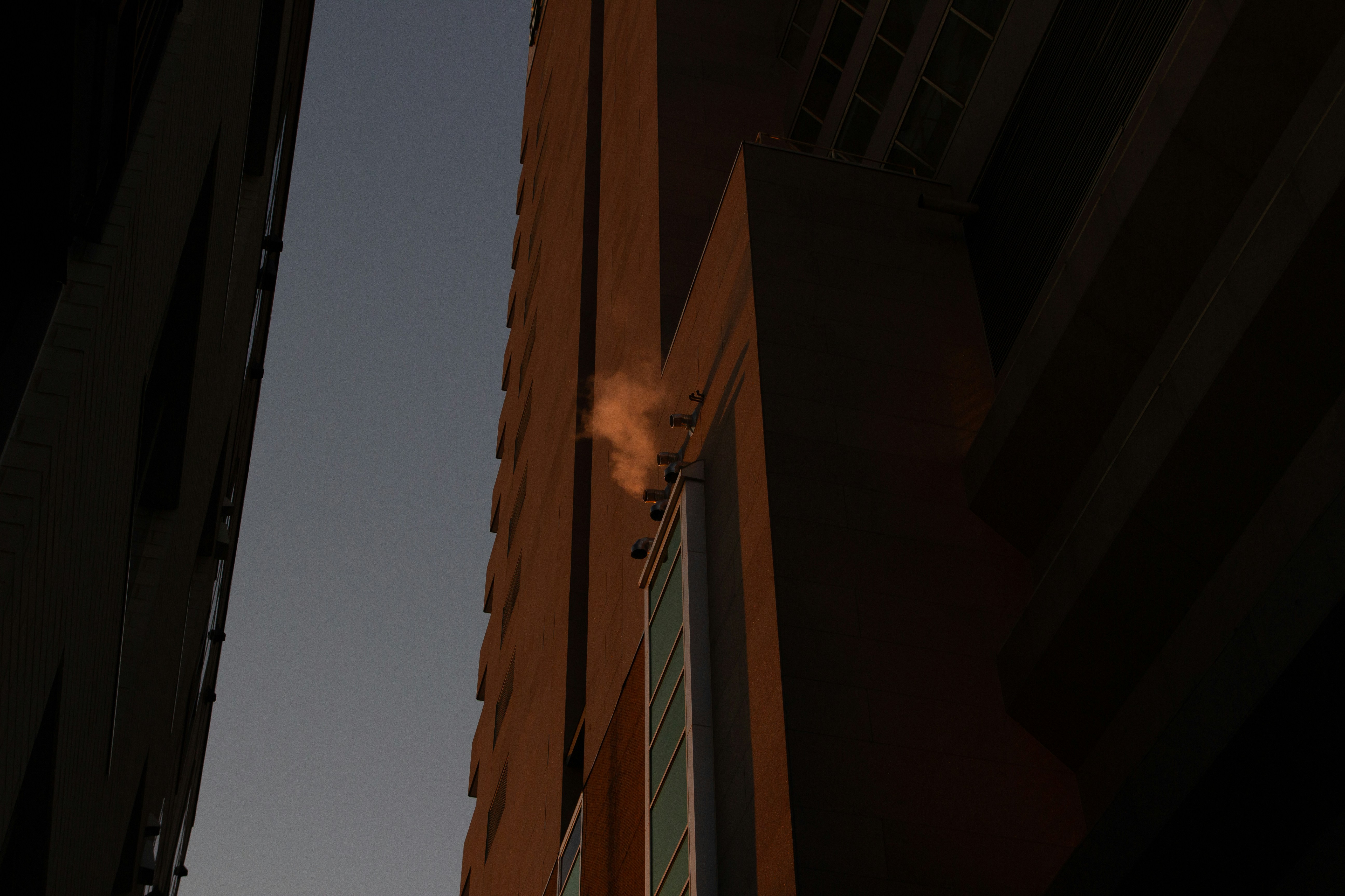 a tall building with smoke coming out of it