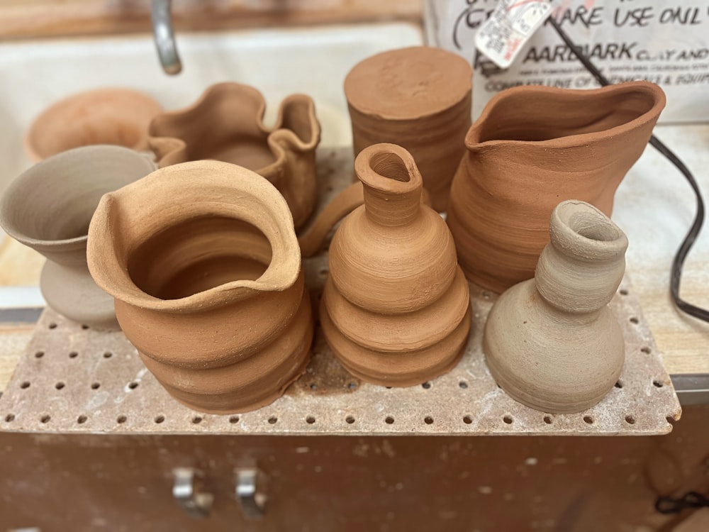 a group of clay pots sitting on top of a table