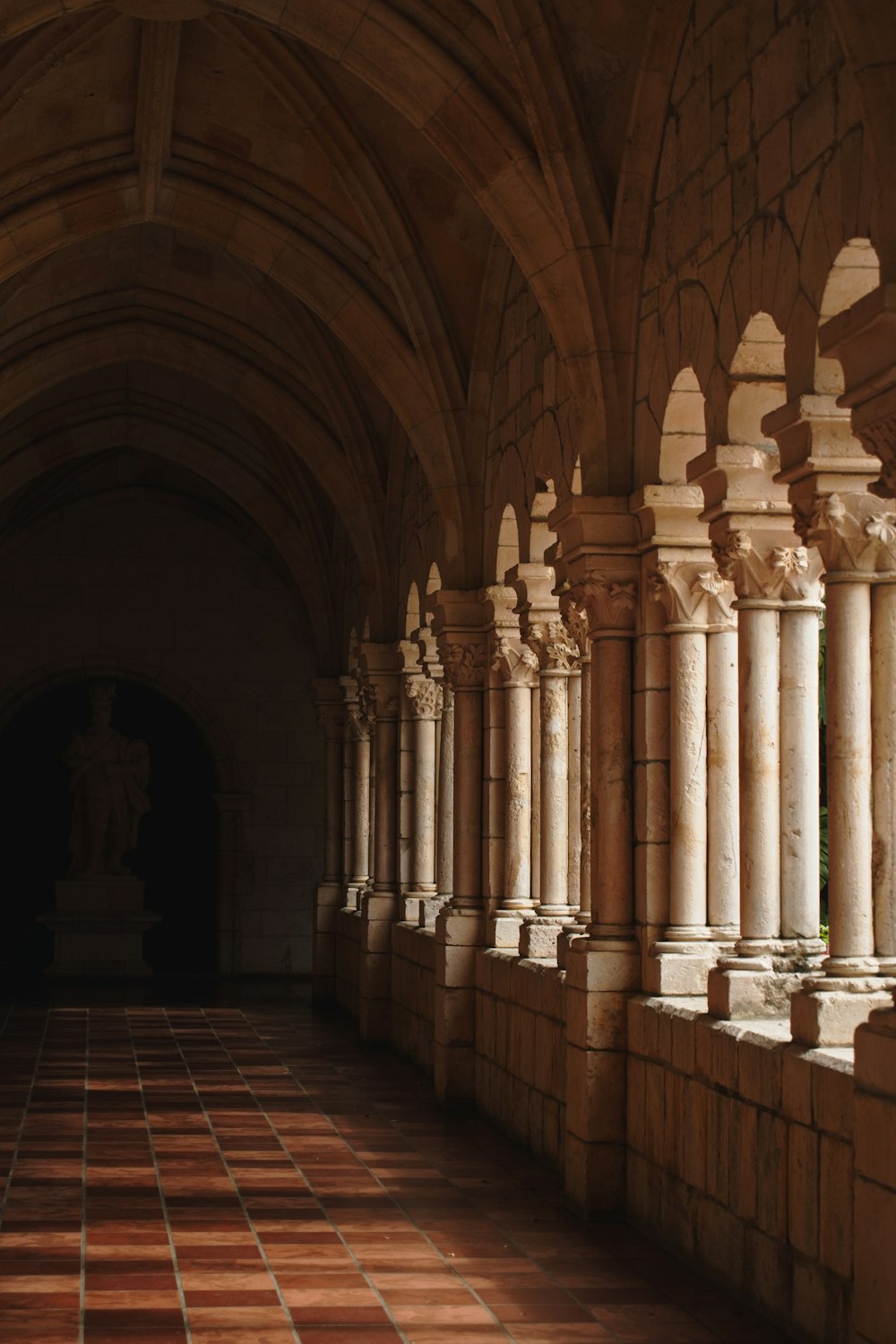 a hallway with columns and a clock on the wall