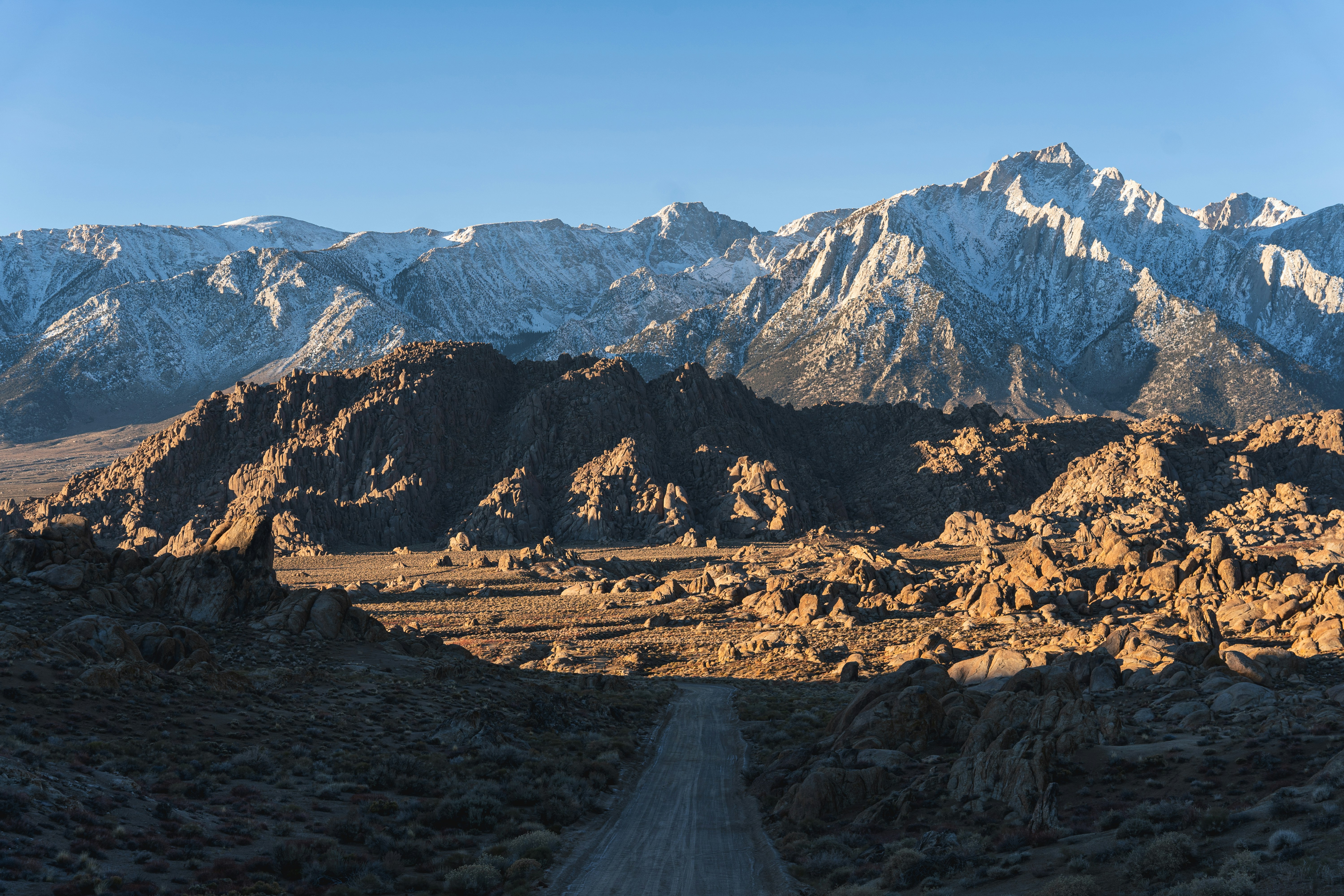 a dirt road in the middle of a mountain range