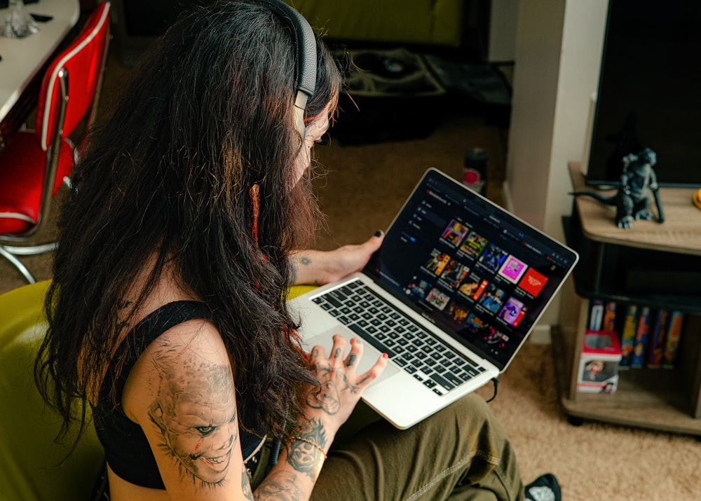 a woman sitting in a chair with a laptop