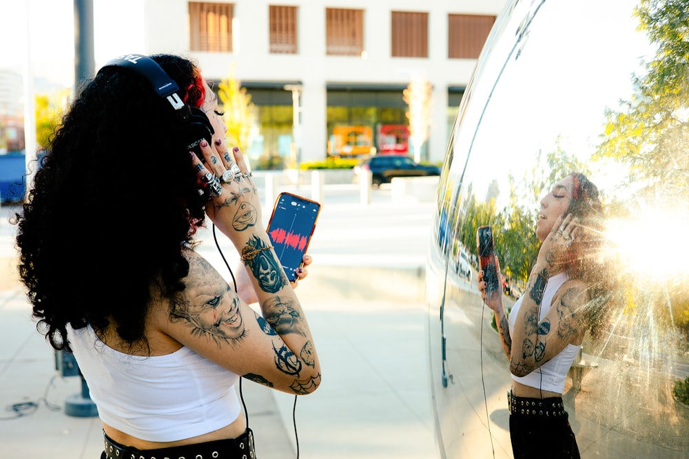 a woman in a white top is talking on a cell phone