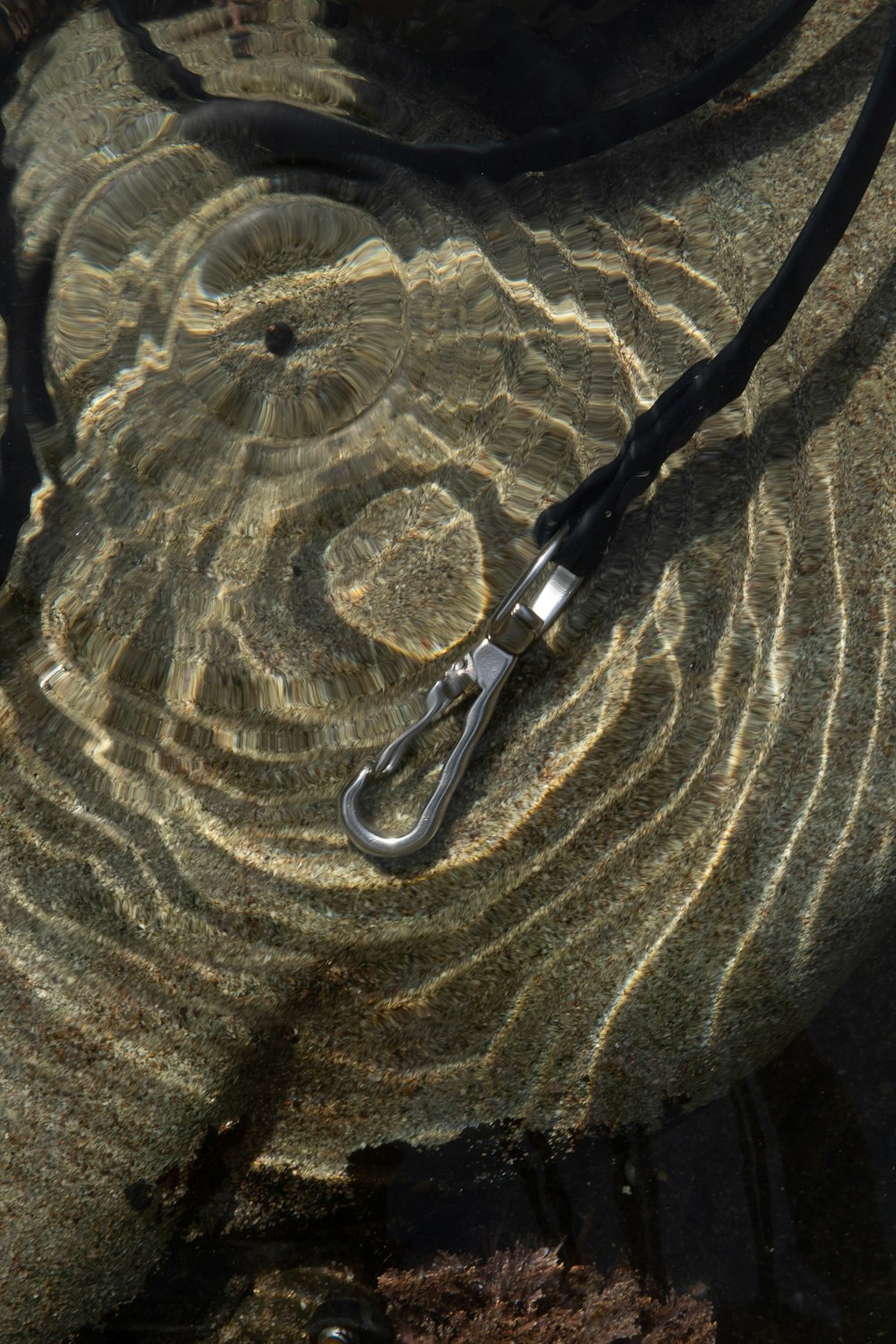 a pair of scissors laying on top of a rock