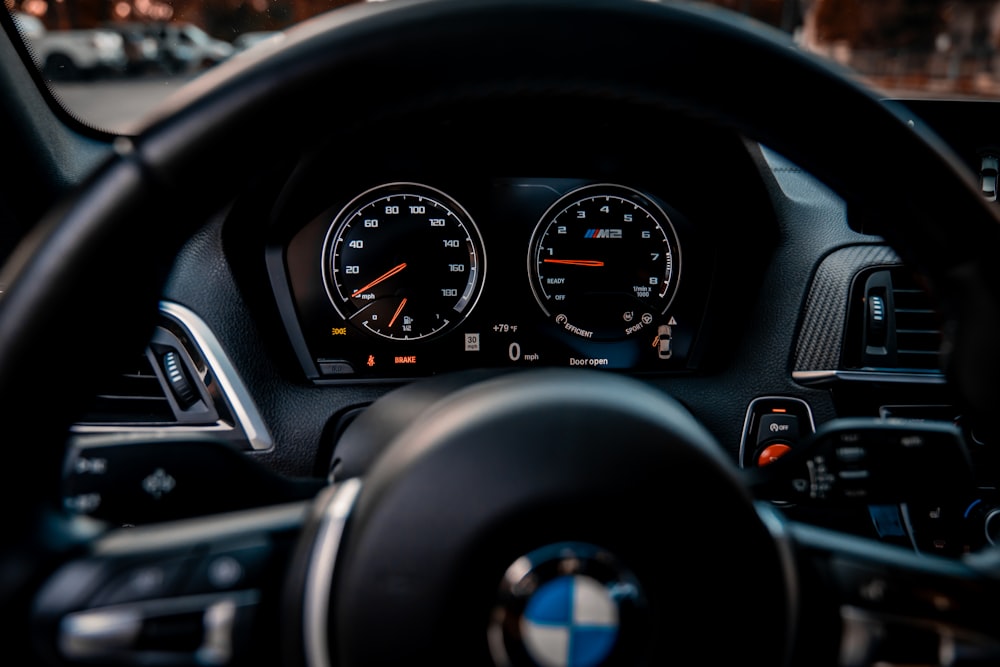 a close up of a car's steering wheel and dashboard