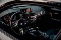 the inside of a car with a dashboard and steering wheel