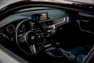 the inside of a car with a dashboard and steering wheel