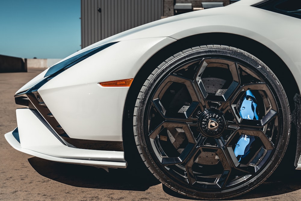 a white sports car parked in a parking lot