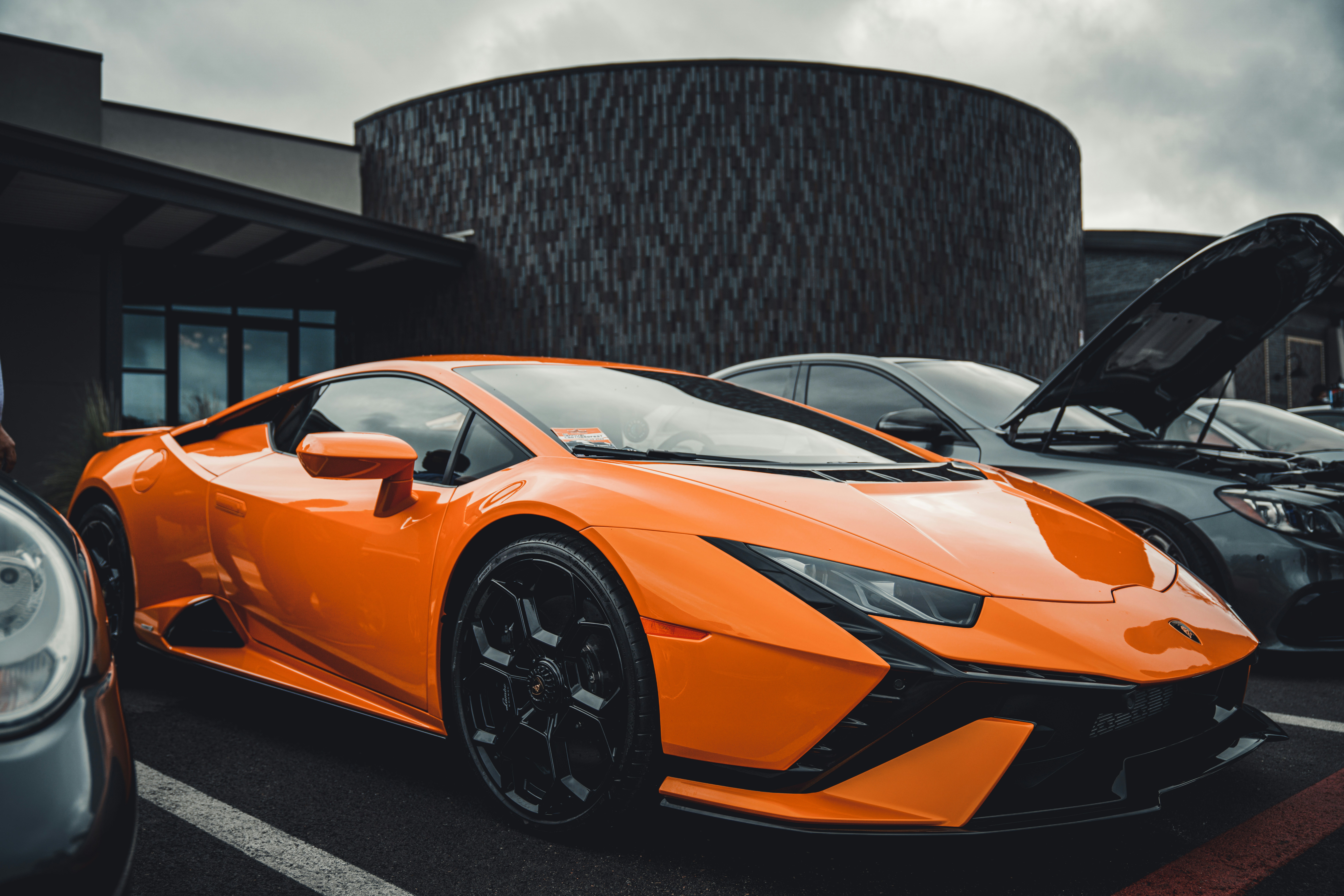 an orange sports car parked in a parking lot