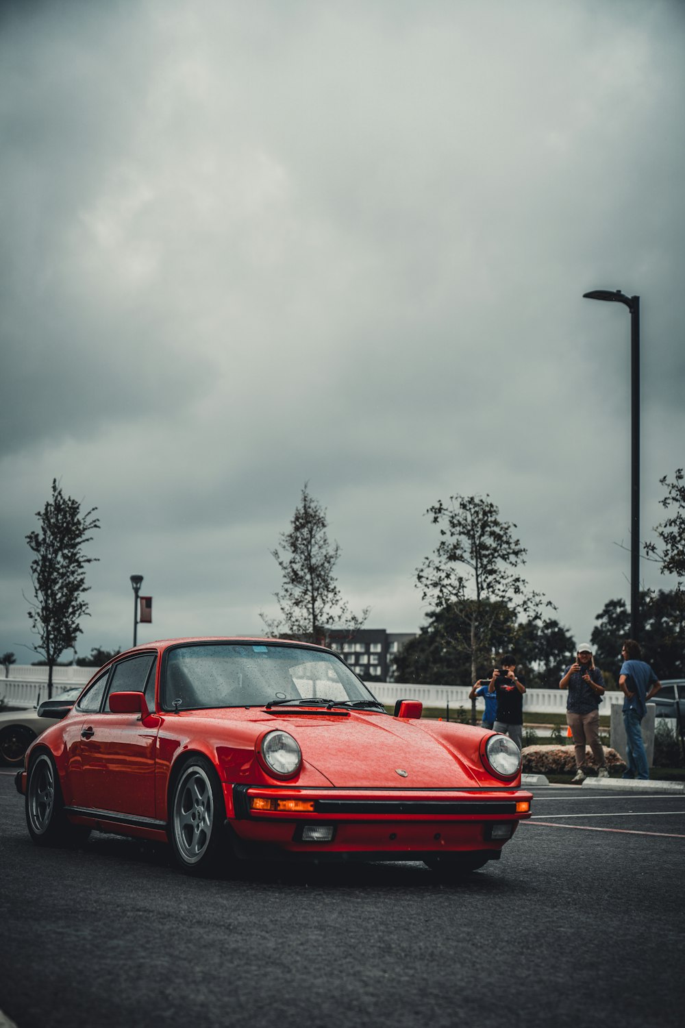 a red sports car parked on the side of the road