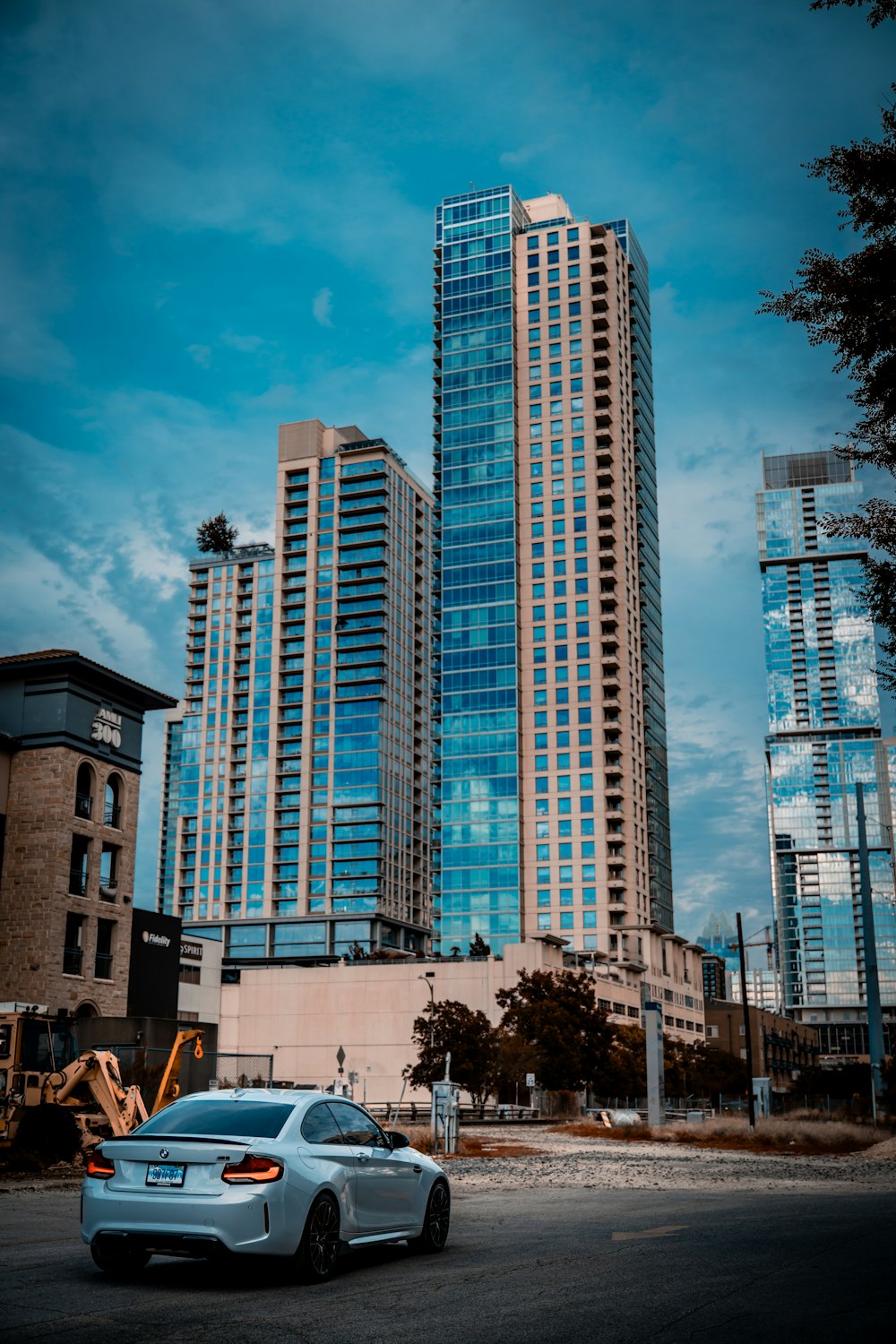 a car parked in front of a tall building