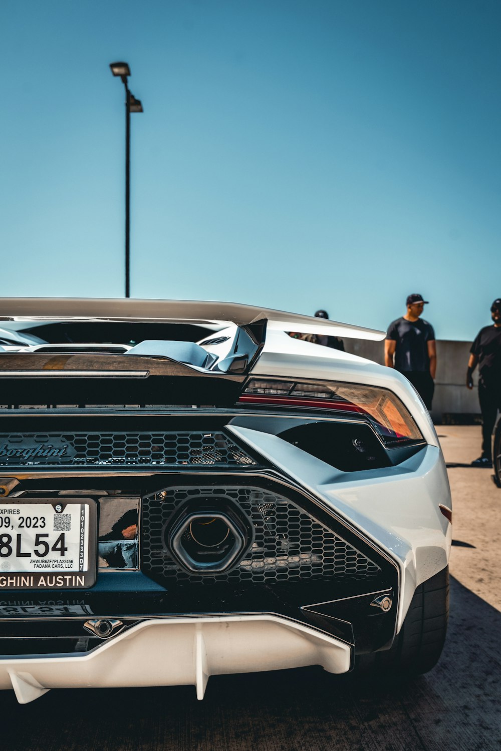 a white sports car parked in a parking lot