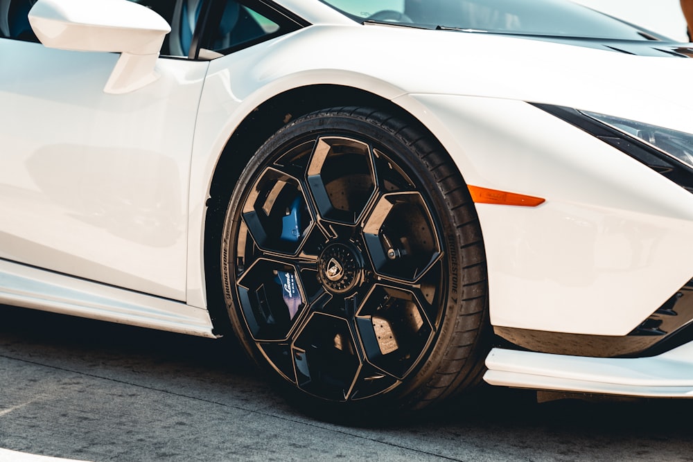 a white sports car parked in a parking lot