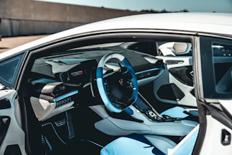 the interior of a car with a steering wheel and dashboard