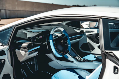 the interior of a car with a steering wheel and dashboard