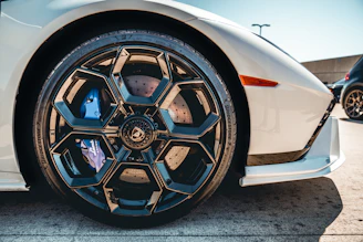 a close up of a white sports car wheel