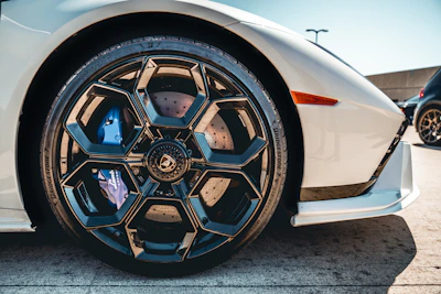 a close up of a white sports car wheel