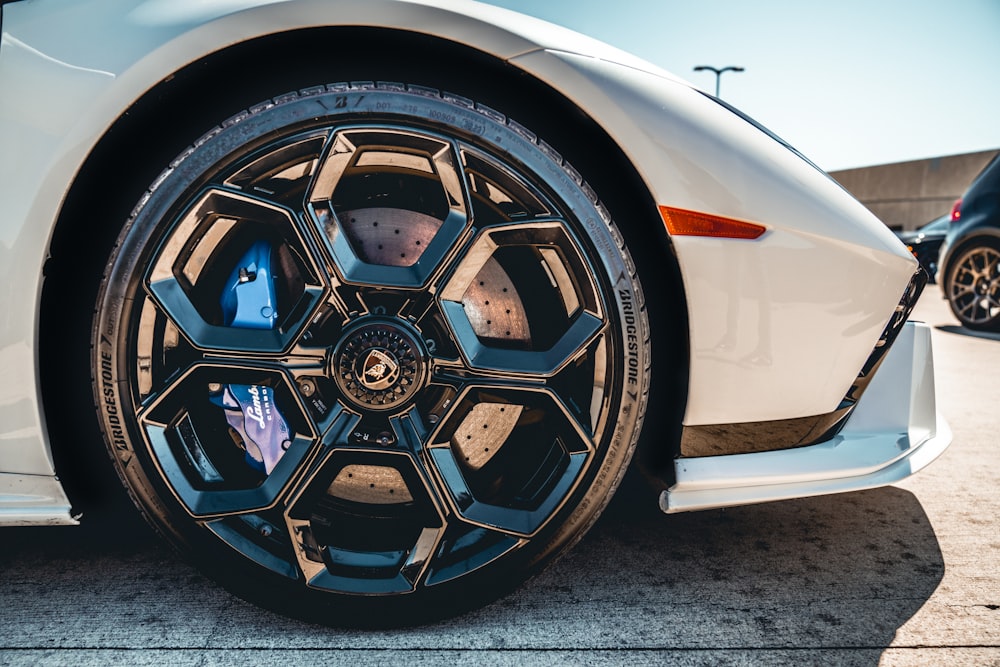 a close up of a white sports car wheel